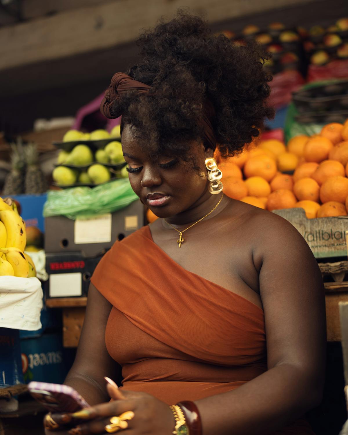 A Kenyan business owner checking WhatsApp messages at the market